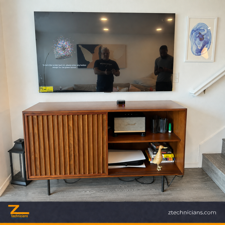 Large flat-screen TV wall mounted above a wooden media console in a Seattle home