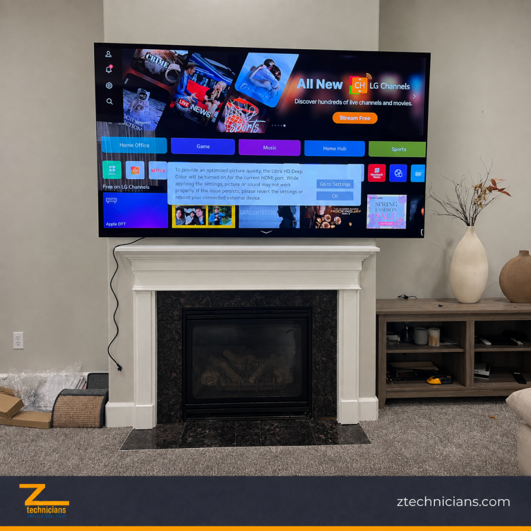 LG TV mounted above a white fireplace mantel by Z Technicians in Seattle