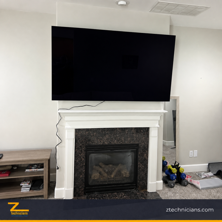 Large-screen TV installation above a white fireplace in a Seattle living room